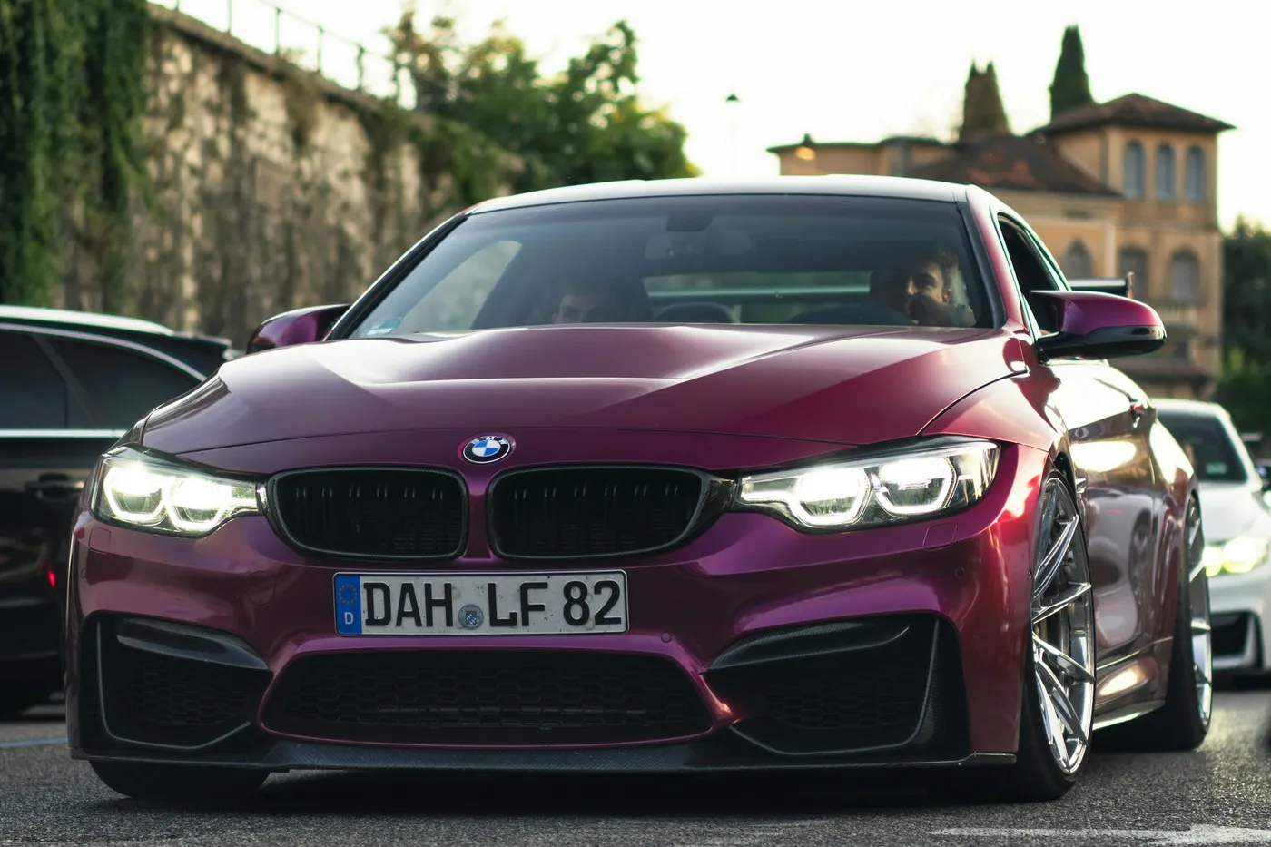 BMW M4 Coupe, vedere față jos, pe o stradă europeană la apus